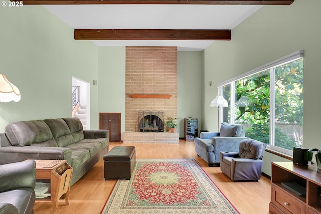 4420 NW 187th Ave, Portland, OR 97229 - living area with a high ceiling, light wood-type flooring, a fireplace, beam ceiling, and stairway