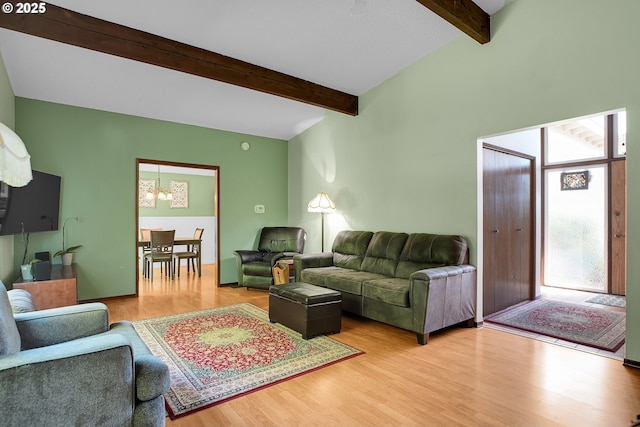 4420 NW 187th Ave, Portland, OR 97229 - living room featuring beamed ceiling, a chandelier, and light wood-style flooring