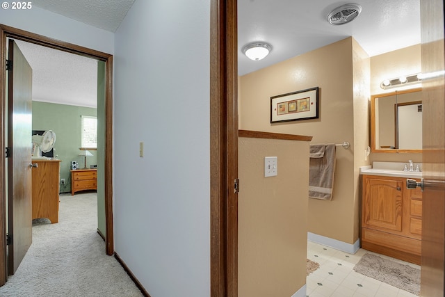 4420 NW 187th Ave, Portland, OR 97229 - hall featuring a textured ceiling and a sink