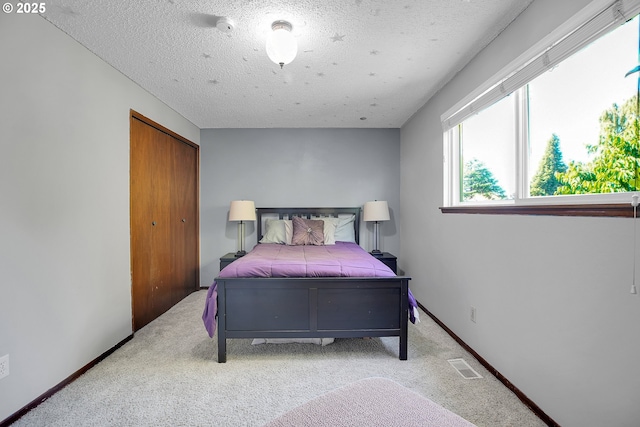 4420 NW 187th Ave, Portland, OR 97229 - bedroom with light colored carpet, a closet, and a textured ceiling