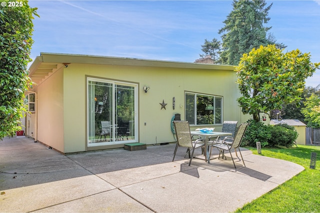 4420 NW 187th Ave, Portland, OR 97229 - rear view of property with a patio, stucco siding, outdoor dining area, and a yard