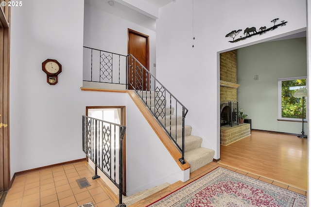 4420 NW 187th Ave, Portland, OR 97229 - staircase with a fireplace and wood finished floors