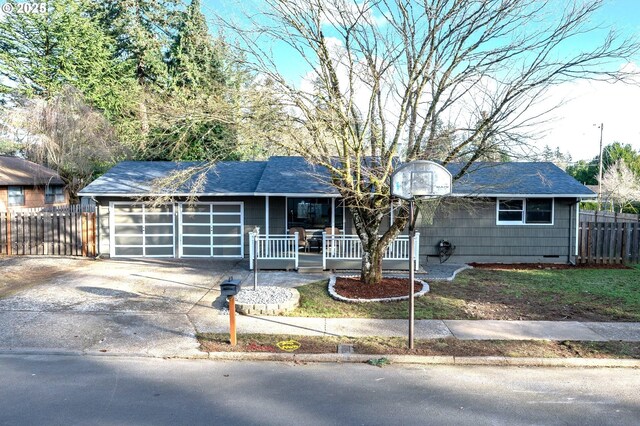 single story home featuring a porch and a garage