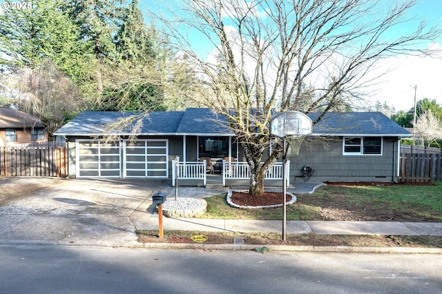 single story home featuring a porch and a garage