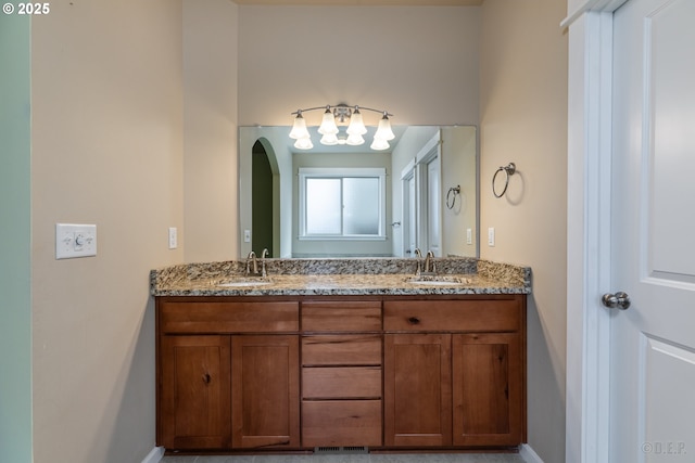 34511 Noble Rd, Saint Helens, OR 97051 - bathroom with baseboards, an inviting chandelier, double vanity, and a sink