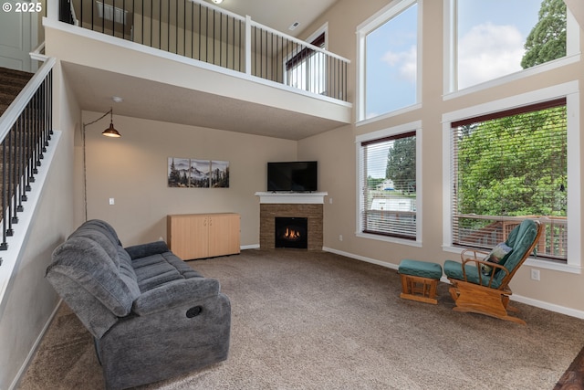 34511 Noble Rd, Saint Helens, OR 97051 - living room with stairway, a high ceiling, a lit fireplace, and carpet floors