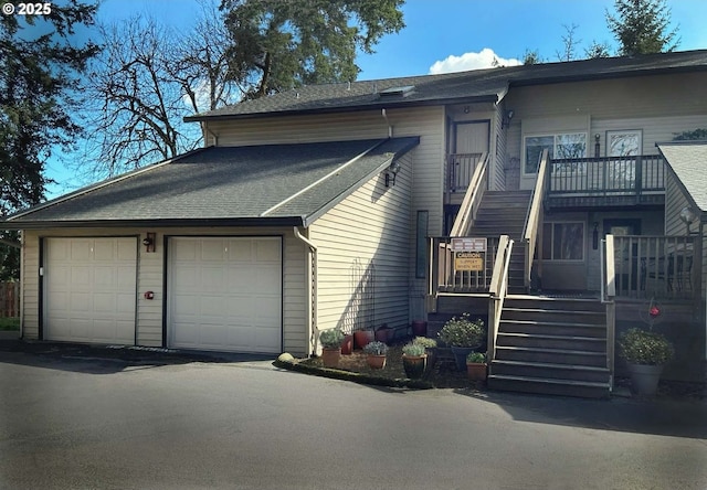 14922 SW 109th Ave, Portland, OR 97224 - view of front of property featuring stairway, a garage, and roof with shingles