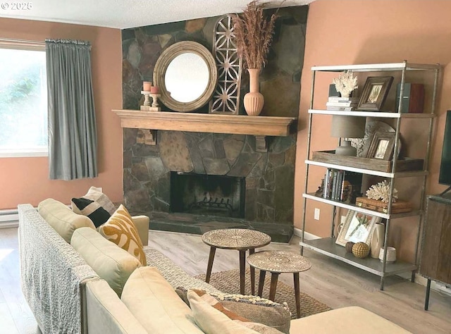 14922 SW 109th Ave, Portland, OR 97224 - living room featuring wood finished floors and a stone fireplace