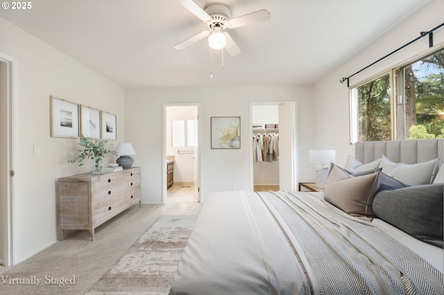 12370 SW 121st Ave, Tigard, OR 97223 - bedroom featuring a spacious closet, light colored carpet, connected bathroom, baseboards, and a ceiling fan