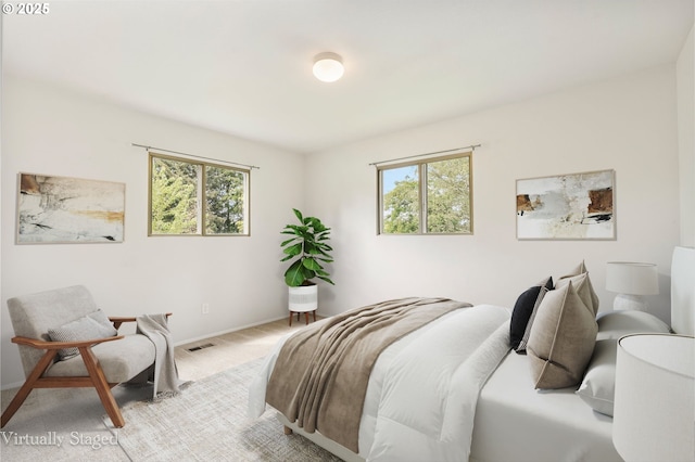 12370 SW 121st Ave, Tigard, OR 97223 - bedroom featuring multiple windows, carpet flooring, and baseboards