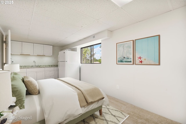 12370 SW 121st Ave, Tigard, OR 97223 - carpeted bedroom with freestanding refrigerator, a sink, and a paneled ceiling