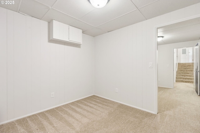 12370 SW 121st Ave, Tigard, OR 97223 - spare room featuring a drop ceiling, light carpet, stairs, and baseboards