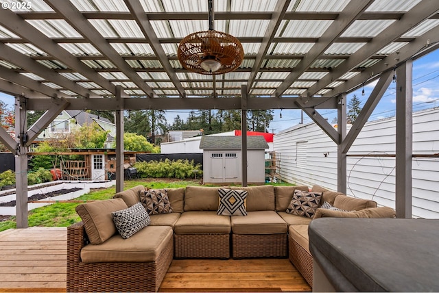 wooden terrace featuring outdoor lounge area, a pergola, and a storage unit