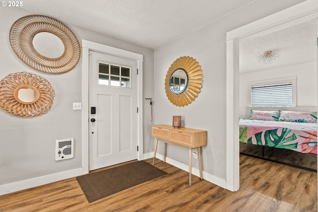 entrance foyer featuring hardwood / wood-style flooring and a textured ceiling