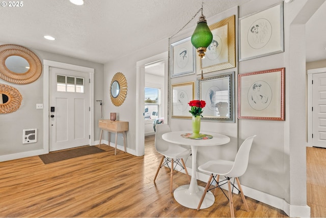 interior space with light hardwood / wood-style flooring and a textured ceiling