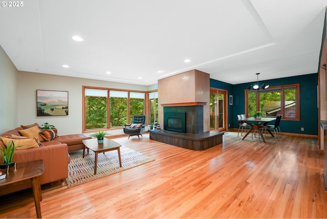 2634 SW Boundary St, Portland, OR 97239 - living area featuring light wood-type flooring, a fireplace, recessed lighting, and a chandelier
