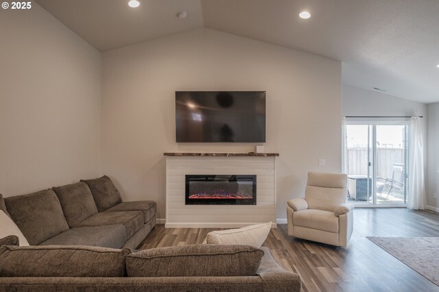 414 SE Ray St, Dallas, OR 97338 - living area featuring a glass covered fireplace, wood finished floors, lofted ceiling, baseboards, and recessed lighting