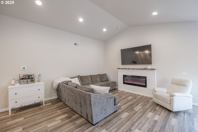 414 SE Ray St, Dallas, OR 97338 - living area with visible vents, vaulted ceiling, a glass covered fireplace, light wood-style floors, and recessed lighting