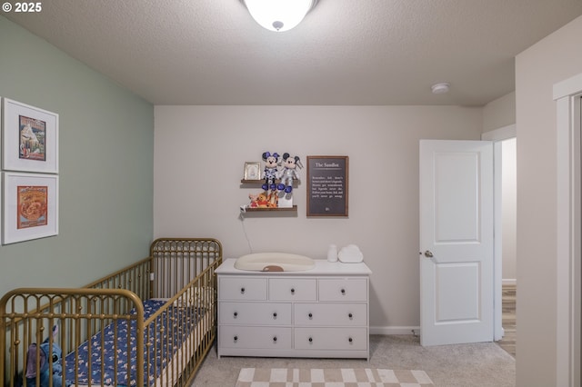 414 SE Ray St, Dallas, OR 97338 - bedroom with light colored carpet, a nursery area, and a textured ceiling