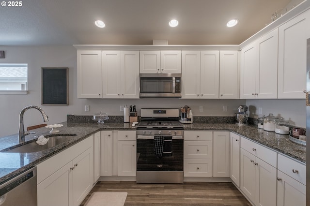 414 SE Ray St, Dallas, OR 97338 - kitchen with white cabinetry, appliances with stainless steel finishes, dark wood-style floors, and a sink