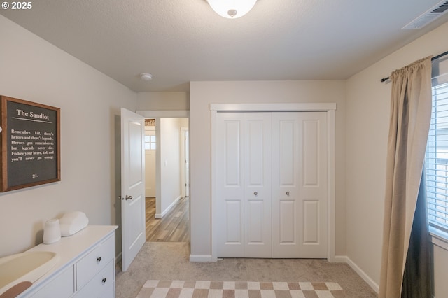414 SE Ray St, Dallas, OR 97338 - bedroom featuring light colored carpet, a closet, baseboards, and visible vents