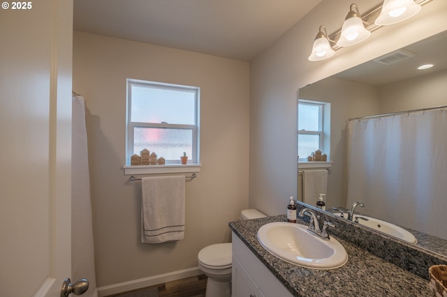 414 SE Ray St, Dallas, OR 97338 - full bathroom with toilet, baseboards, visible vents, vanity, and wood finished floors