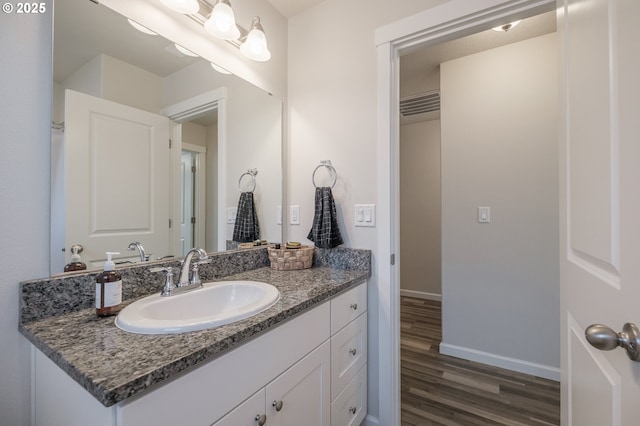 414 SE Ray St, Dallas, OR 97338 - bathroom with baseboards, wood finished floors, and vanity