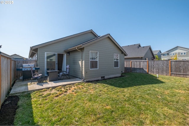 414 SE Ray St, Dallas, OR 97338 - back of property with a lawn, a patio, and a fenced backyard