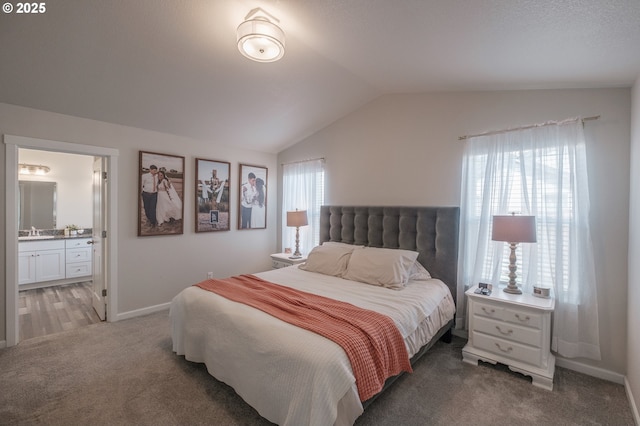 414 SE Ray St, Dallas, OR 97338 - carpeted bedroom featuring baseboards, a sink, lofted ceiling, and ensuite bath