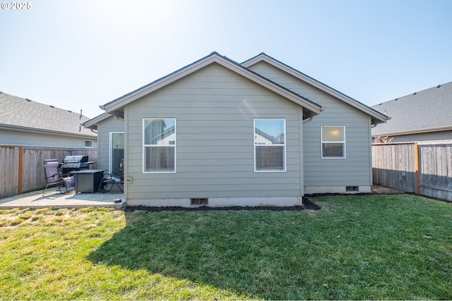 414 SE Ray St, Dallas, OR 97338 - rear view of house featuring a fenced backyard, a lawn, and a patio area