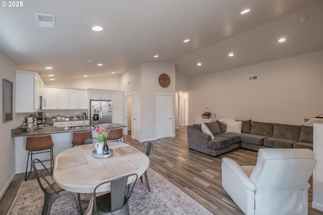 414 SE Ray St, Dallas, OR 97338 - living area with lofted ceiling, visible vents, and wood finished floors