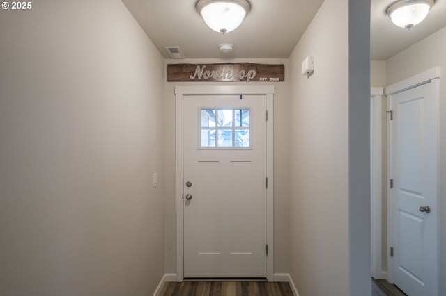 414 SE Ray St, Dallas, OR 97338 - doorway with baseboards, dark wood-type flooring, and visible vents