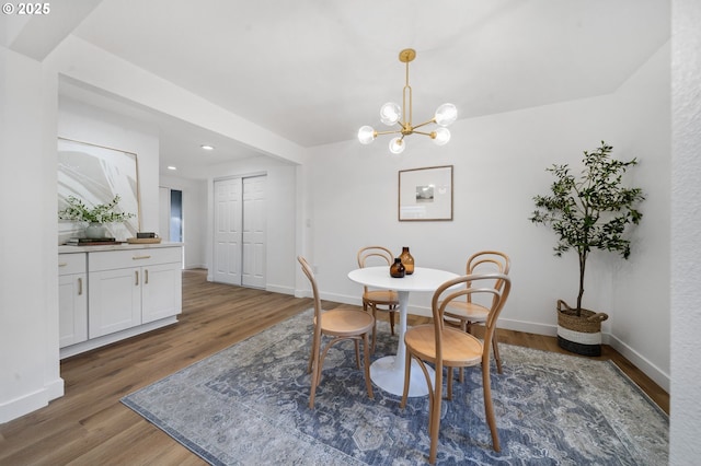 dining area featuring dark hardwood / wood-style floors and an inviting chandelier