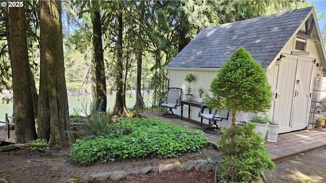view of yard featuring an outbuilding, a wooden deck, and a shed