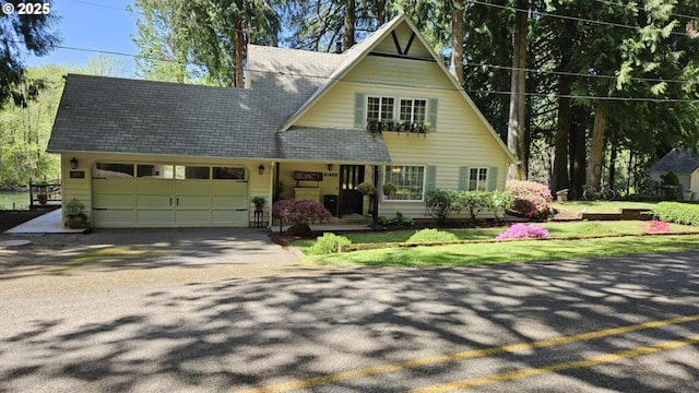 view of front of property with an attached garage, concrete driveway, and a chimney