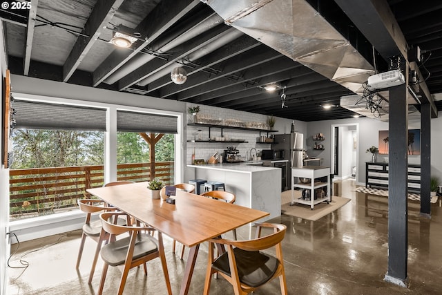 10951 SE Valley View Ter, Happy Valley, OR 97086 - dining space with finished concrete flooring, plenty of natural light, and bar with sink