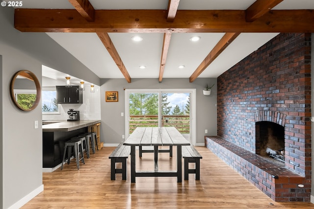 10951 SE Valley View Ter, Happy Valley, OR 97086 - dining area with beam ceiling, light wood-type flooring, baseboards, recessed lighting, and a brick fireplace