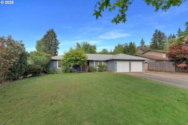 single story home featuring a garage and asphalt driveway