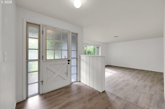 entryway with wood finished floors and baseboards