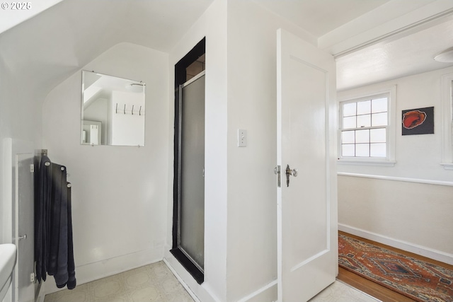 bathroom with baseboards and a shower stall