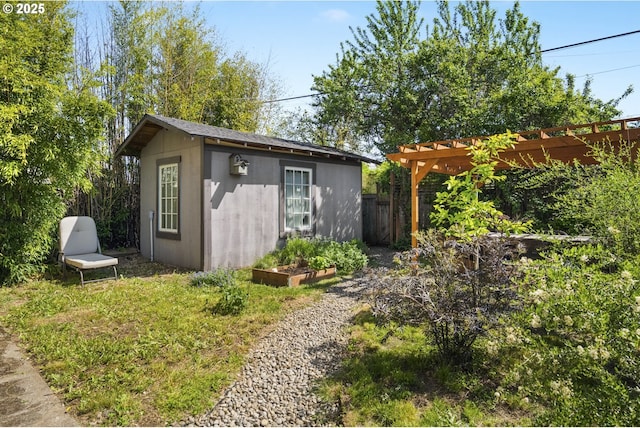 view of outbuilding featuring fence, an outbuilding, and a pergola