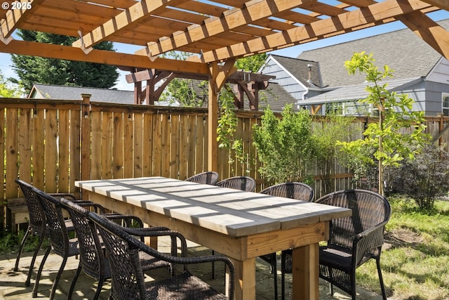 view of patio featuring fence, a pergola, and outdoor dining space
