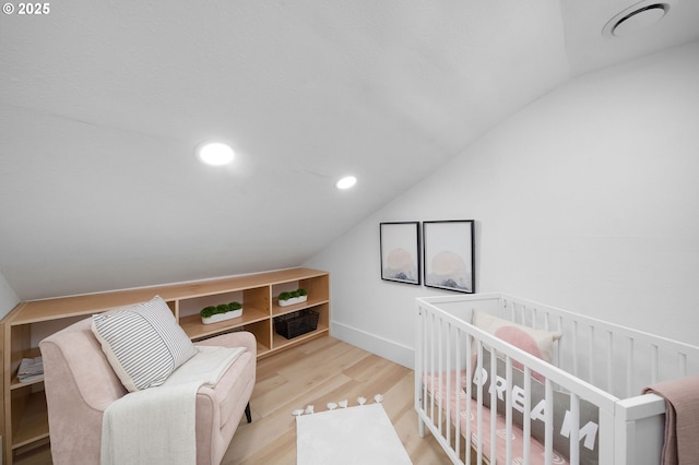 3321 NE 13th Ave, Portland, OR 97212 - bedroom with vaulted ceiling, wood finished floors, and recessed lighting
