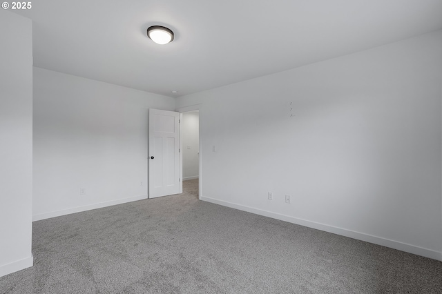 carpeted spare room with baseboards