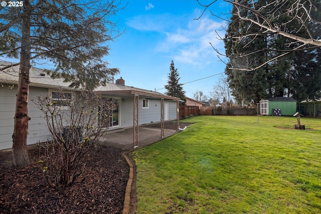 view of yard featuring a patio, an outbuilding, a fenced backyard, and a shed