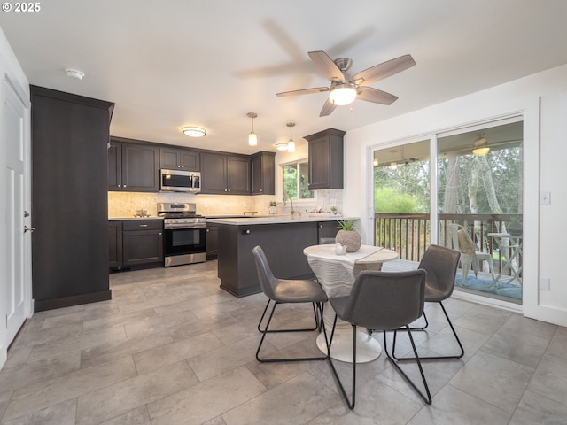 dining space with a ceiling fan and baseboards