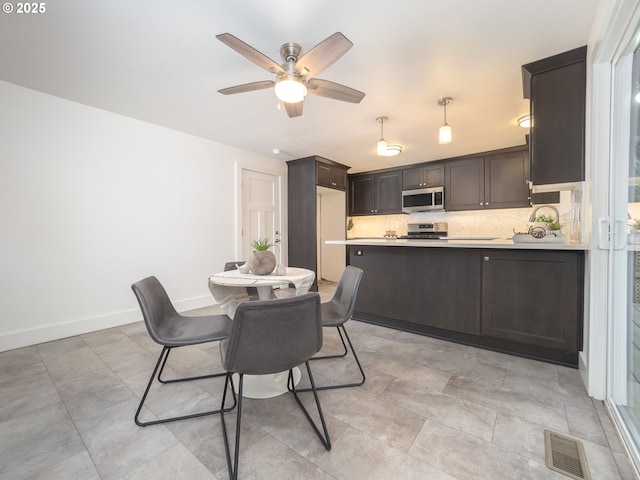 dining space with visible vents, baseboards, and ceiling fan