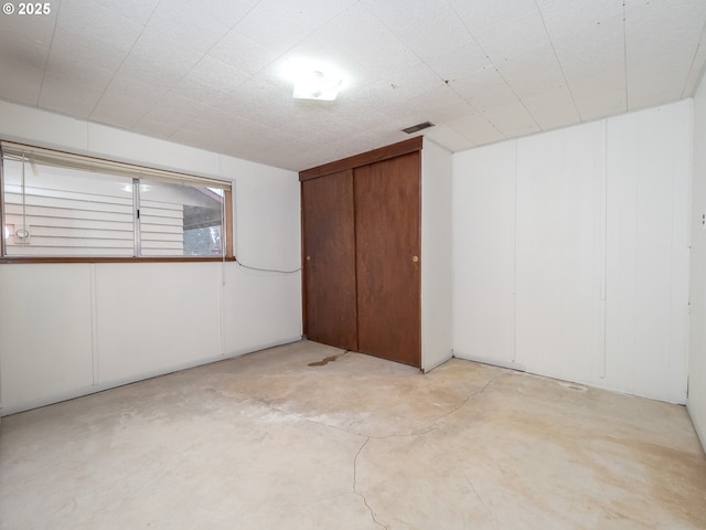 interior space featuring visible vents, concrete floors, and a closet