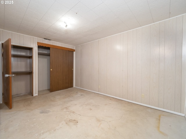 unfurnished bedroom featuring a closet and unfinished concrete floors