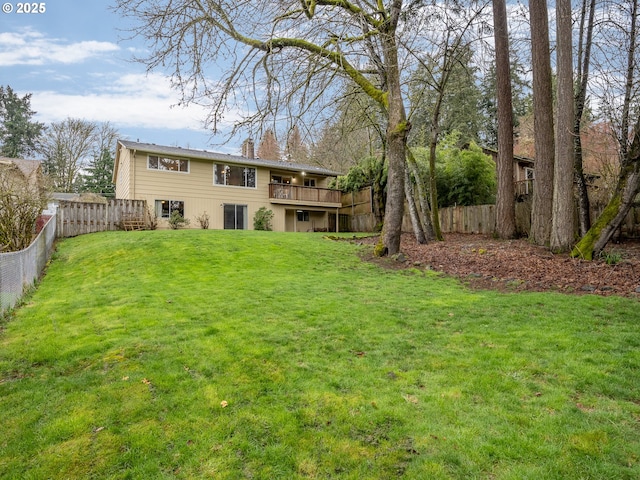 rear view of property featuring a yard, a fenced backyard, a wooden deck, and a chimney